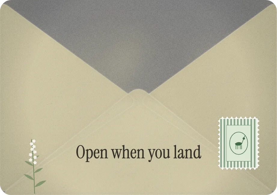 A cream envelope with a stamp, a sprig of hawthorn and the words: Open when you land.